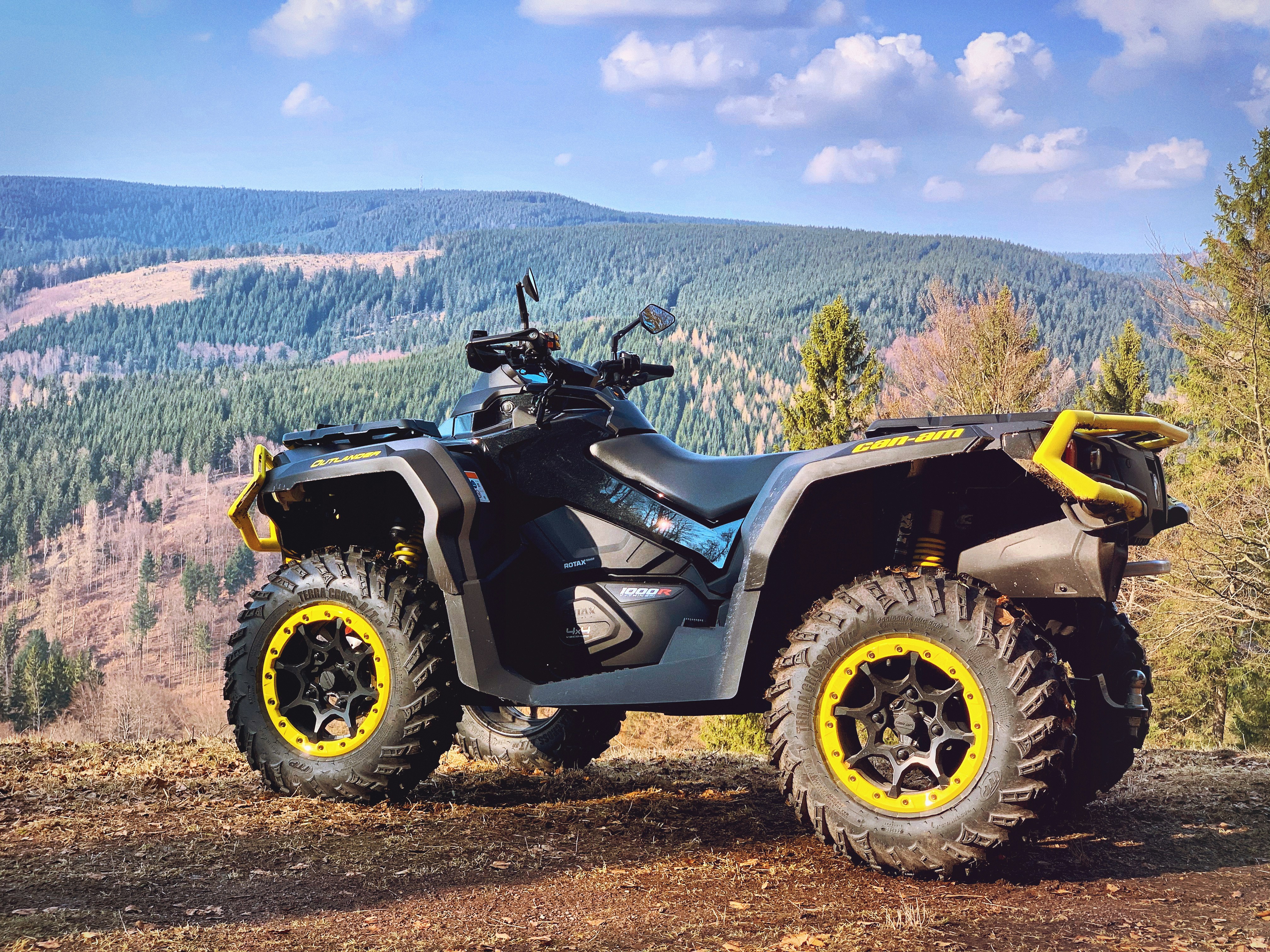 Man standing in the ATV in a rugged terrain