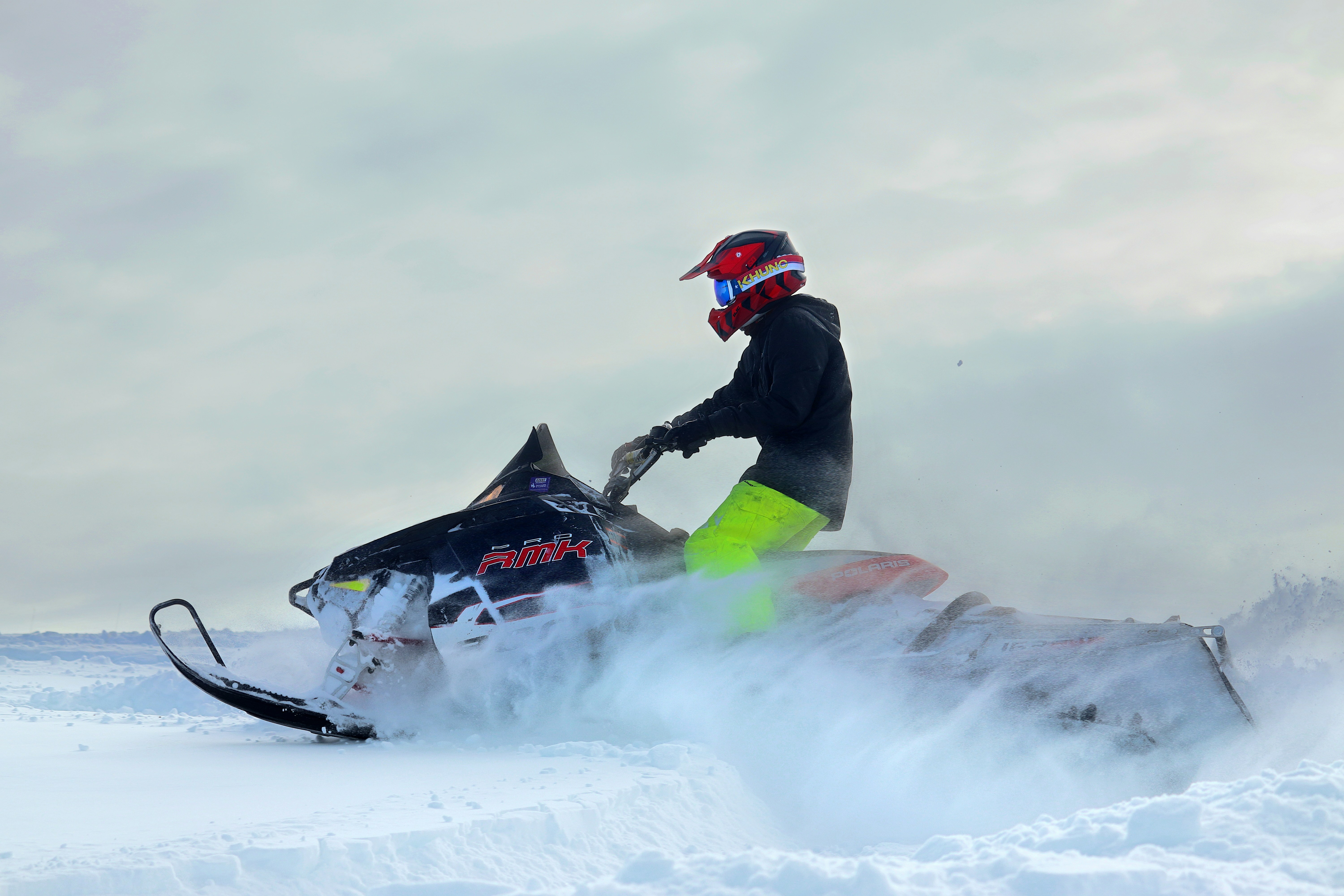 Man riding a snowmobile in a snowy mountain